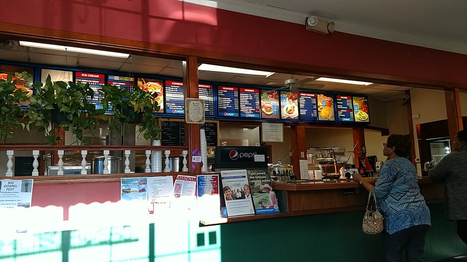 Drive-in restaurant entrance with parking.